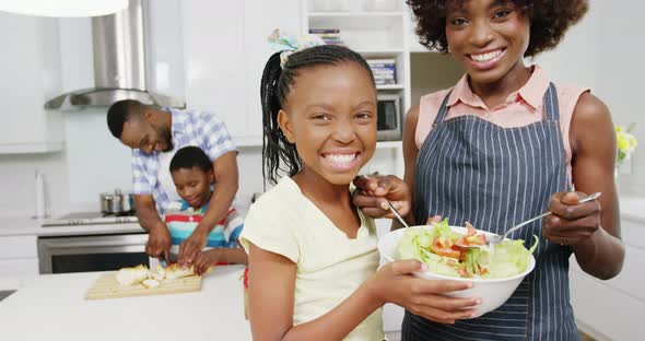 Happy family preparing food in kitchen