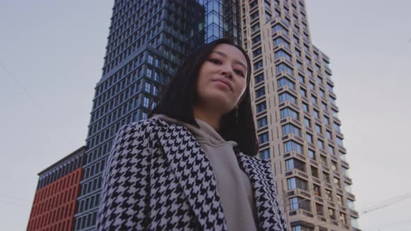 Portrait of a Businesswoman Under a Highrise Building