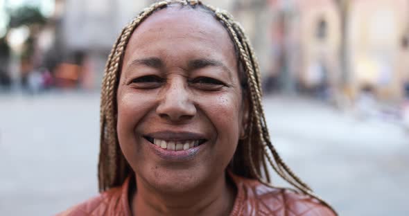 African senior woman smiling on camera outdoor