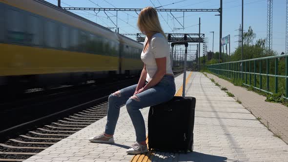 A Young Beautiful Woman Waits for a Train