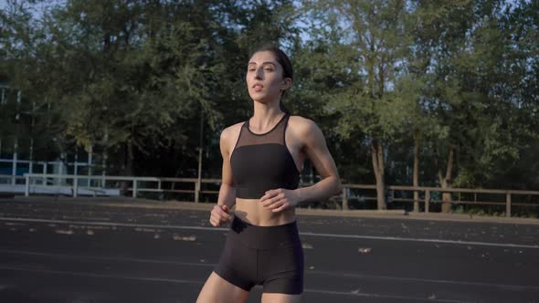 Girl Runs Across the Stadium Trains and Prepares to Compete on Summer Day