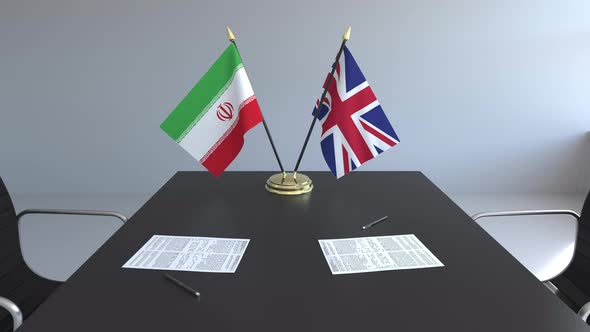 Flags of Iran and United Kingdom on the Table