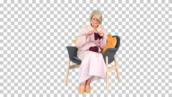 Intelligent old lady knitting sitting on a chair, Alpha Channel