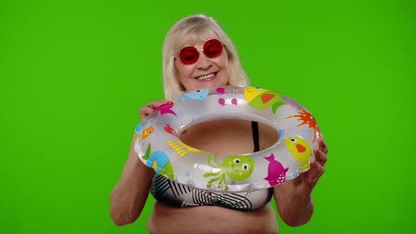 Senior Pensioner Woman Tourist Dancing Celebrating Smiling with Rubber Swim Ring on Chroma Key