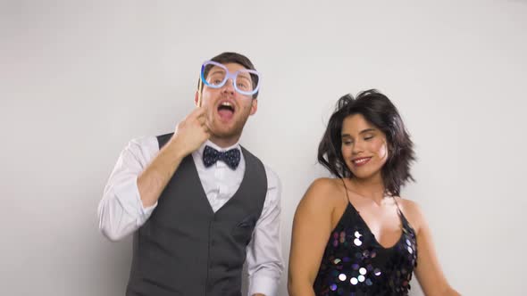 Couple with Party Props Having Fun and Dancing