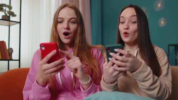 Girls Friends Siblings Celebrate Success Win Scream Rejoices Doing Online Shopping on Smartphone