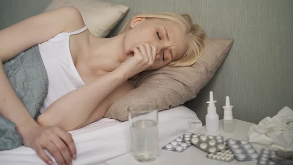 Young Ill Woman in Bed at Home