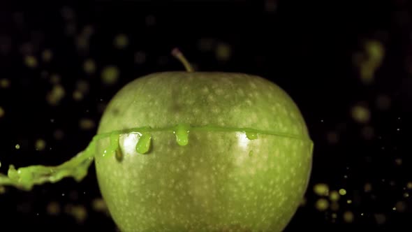 Half Green Apple Falling and Splashing on Black Background