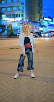 Blonde Lady in Trendy Striped Pants Pose Dancing in Street