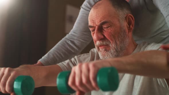 Elderly Couple Exercising with Dumbbells