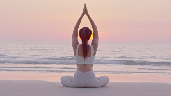 Young Asian lady warming up her hands with exercise