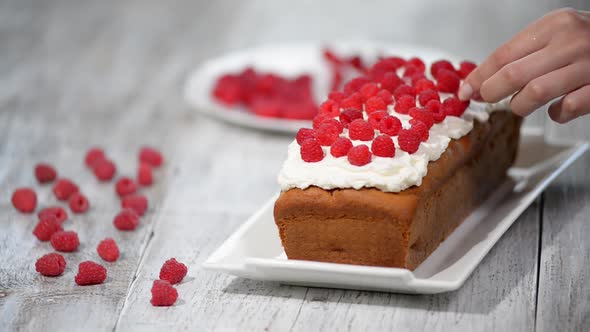 Decorate pound cake with raspberries. 