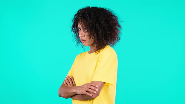 Angry Offended African Woman Keeping Arms Crossed and Staring at Camera with Sceptical Look Feeling