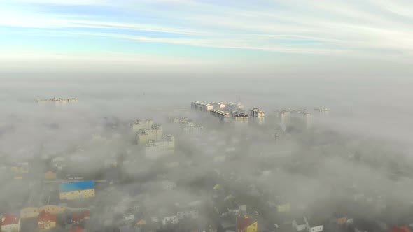 Aerial View at the Houses That Are Covered with Morning Fog. Flight Over the City of Lviv in Ukraine