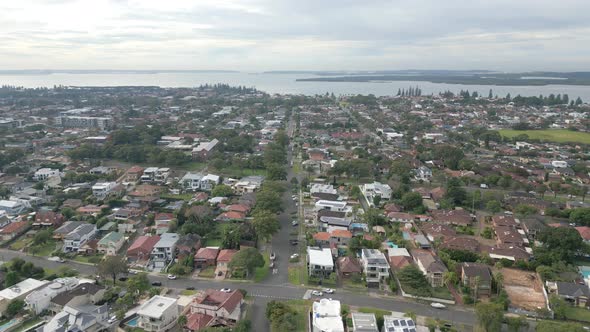 Aerial view of luxury neighborhood residential homes and roads from above. Featuring the quiet stree