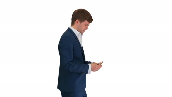 Happy Businessman Counting Money and Tucking It Inside His Jacket While Walking on White Background