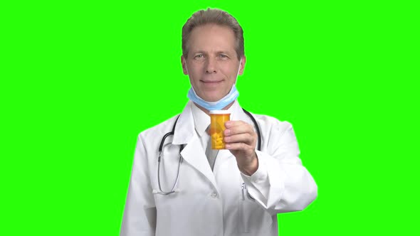 Mature Doctor Advertising Can of Pills.