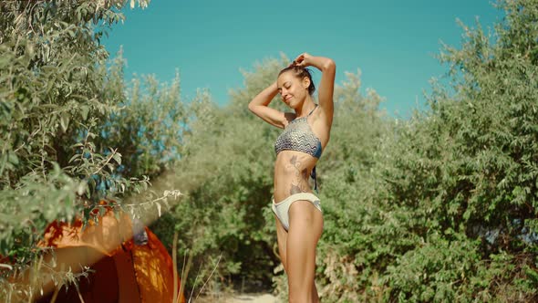 Relaxed Beautiful Mixed Race Woman in Bikini Enjoying Sunny Morning in Camping on Sandy Beach