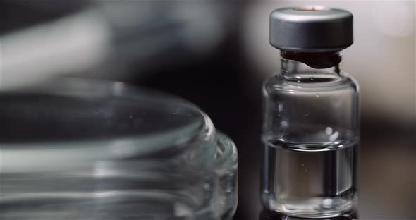 Syringe and Various Medicines on Table