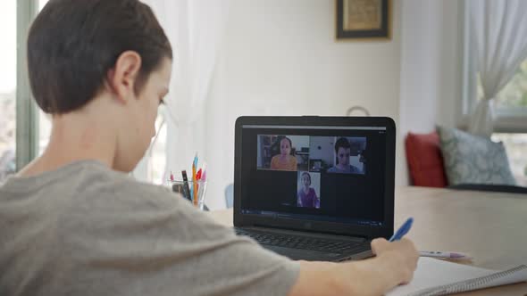 Young boy attending an online lesson during the COVID-19 lockdown