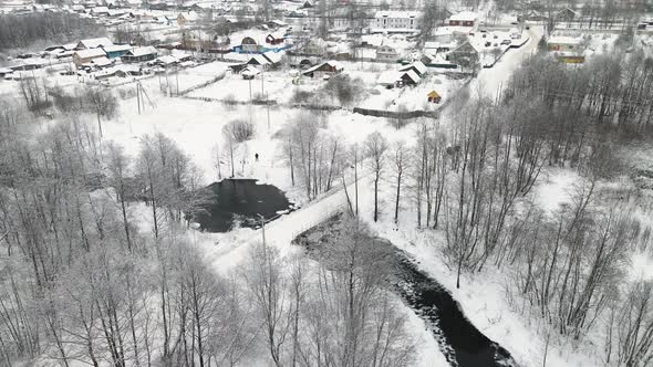 A Striking Winter Landscape with an Icefree River Aerial View