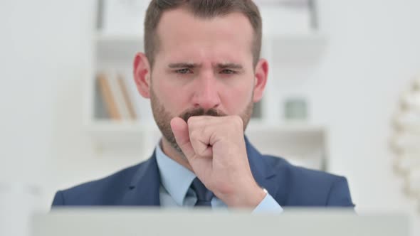 Portrait of Sick Businessman with Laptop Coughing 