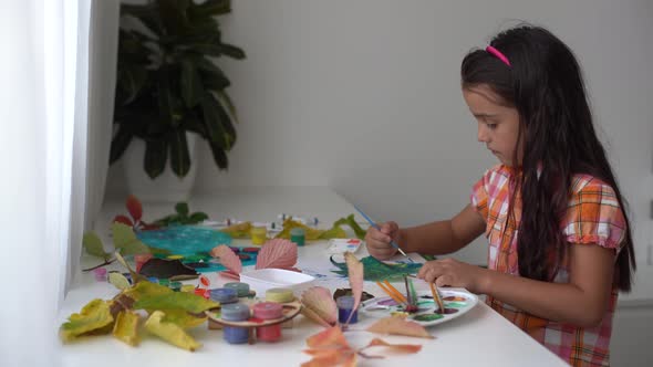 Little Girl Painting on Autumn Yellow Leaves with Gouache Kids Arts Children Creativity Autumn