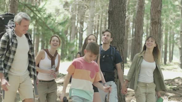 Family hiking through forest together