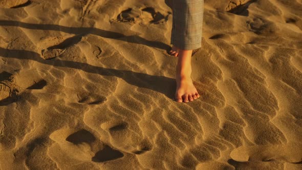 Barefoot Woman Walking Along the Sand Leaving Footprints in Slowmo