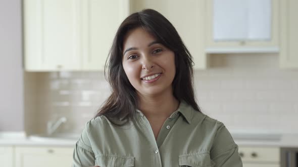 Smiling Young Indian Woman Looking at Camera at Home in Kitchen Headshot