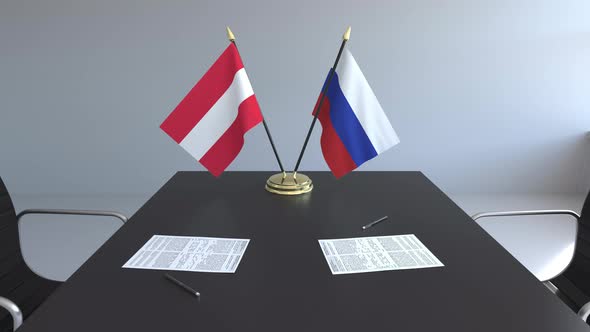 Flags of Austria and Russia and Papers on the Table alt