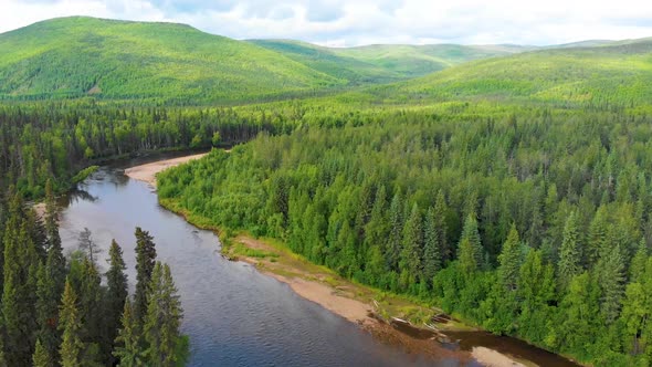 4K Drone Video of Beautiful Chena River as it runs through Pine Tree Covered Mountains near Chena Ho