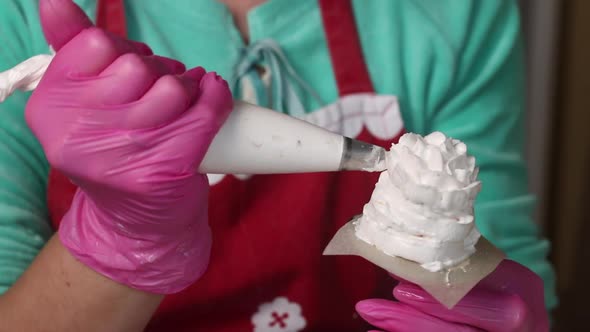 Woman Makes Marshmallow Cones. Using A Pastry Bag, On A Stand. Close Up Shot.