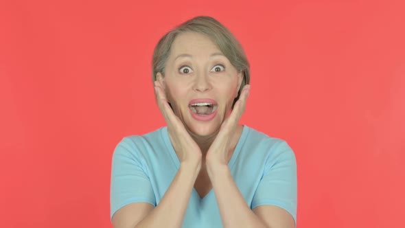 Surprised Old Woman Feeling Amazed on Red Background