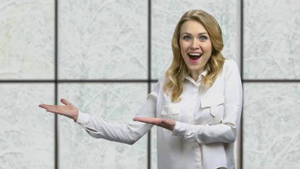 Young Shocked Business Woman Pointing at Copy Space