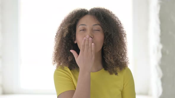 Flying Kiss by African Woman