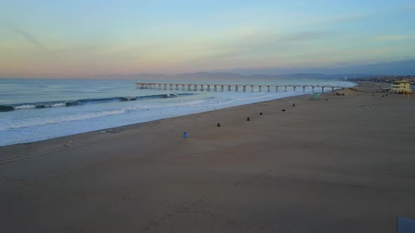 Aerial drone uav view of a lifeguard tower, pier, beach and ocean.