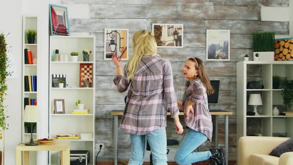 Beautiful Young Mother Dancing with Her in the Room