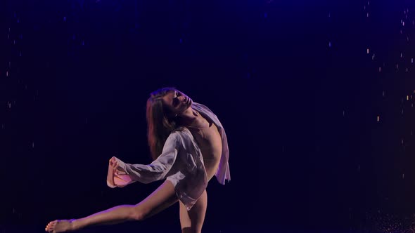 Woman in White Shirt is Dancing Dramatic Dances of Modern Ballet in Rain