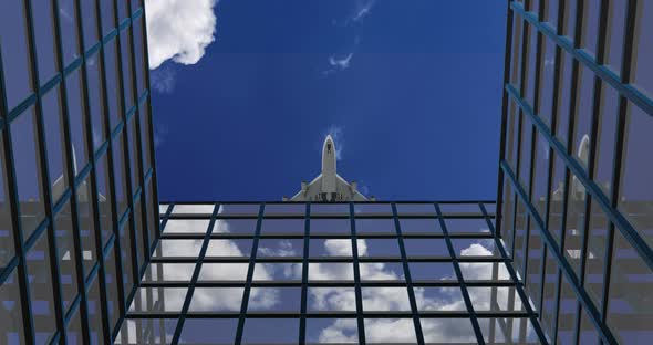 Airplane Flies Over Business Skyscrapers Against Clouds