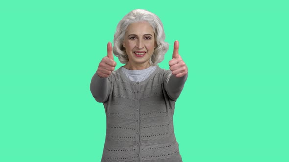 Smiling Mature Woman Giving Two Thumbs Up.