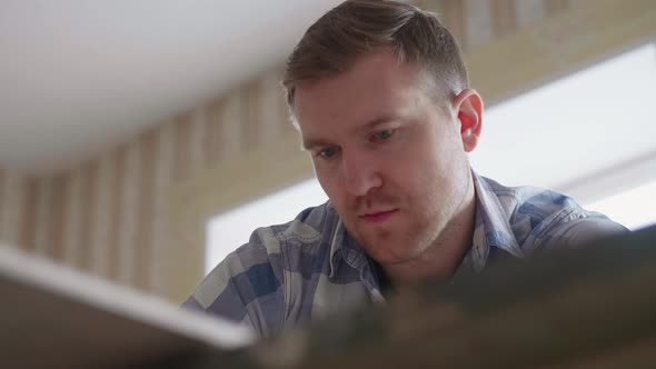 Carpenter Makes Pencil Markings on the Blank with the Help of a Ruler