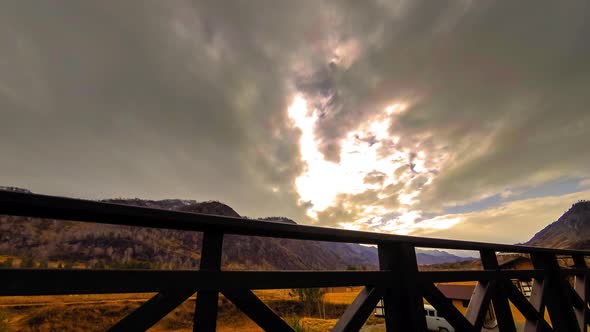 Timelapse of Wooden Fence on High Terrace at Mountain Landscape with Clouds