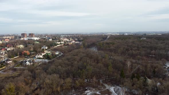 Fly above city street, residential area in winter