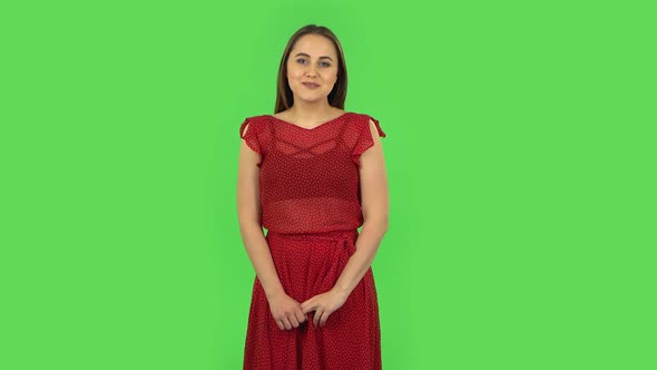 Tender Girl in Red Dress Is Looking with Tenderness Smile. Green Screen