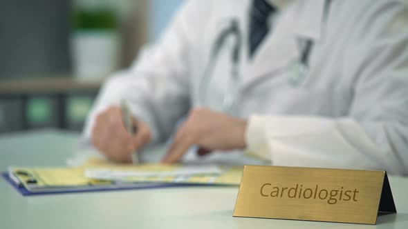 Cardiologist Prescribing Medication for Coronary Heart Disease in Clinic