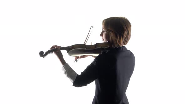 Girl Performs a Musical on a Violin in a studio.White Background