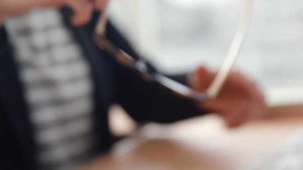 Businesswoman wearing spectacle at her desk