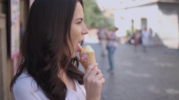 Beautiful Brunette Woman Eating Delicious and Sweet Ice Cream