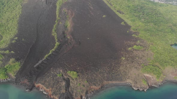 Aerial: flying over Banda Islands active volcano Gunung Api lava flow Indonesia